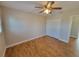 A clean bedroom features wood-look floors, a ceiling fan, and closet at 6187 Brookhill Cir, Orlando, FL 32810