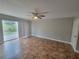 Bright, empty bedroom with sliding glass doors and tile flooring offers a spacious and airy feel at 6187 Brookhill Cir, Orlando, FL 32810