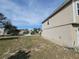 Exterior side view of the home showing the yard and surrounding neighborhood at 6187 Brookhill Cir, Orlando, FL 32810