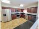 Well-lit kitchen featuring stainless steel appliances, dark wood cabinets, and granite countertops at 6187 Brookhill Cir, Orlando, FL 32810