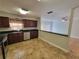 Open kitchen view, featuring stainless steel appliances, dark cabinets, and granite countertops at 6187 Brookhill Cir, Orlando, FL 32810