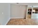 Neutral living room with tile flooring, seamlessly connects to the adjacent kitchen at 6187 Brookhill Cir, Orlando, FL 32810