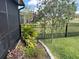 Manicured backyard featuring flowers, lush vegetation and a black metal fence at 2188 Palm Tree Dr, Kissimmee, FL 34759