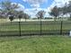Fenced backyard featuring green grass and water view at 2188 Palm Tree Dr, Kissimmee, FL 34759