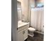 Cozy bathroom featuring a single sink vanity, toilet and bathtub with a shower and grey floor tiling at 2188 Palm Tree Dr, Kissimmee, FL 34759