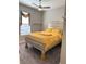 Bedroom with a large window and a bed covered with a yellow bedding set at 2188 Palm Tree Dr, Kissimmee, FL 34759