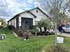 Well-maintained single-Gathering home boasts a lush lawn, manicured landscaping, and a charming front porch at 2188 Palm Tree Dr, Kissimmee, FL 34759