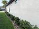 Exterior of the house features a manicured lawn with neatly trimmed shrubs along the side of the home at 2188 Palm Tree Dr, Kissimmee, FL 34759
