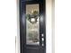 Close-up of a stylish front door with decorative wreath and modern hardware, adding charm and security at 2188 Palm Tree Dr, Kissimmee, FL 34759