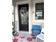 Elegant glass front door adorned with a festive wreath, enhancing the home's curb appeal at 2188 Palm Tree Dr, Kissimmee, FL 34759