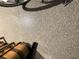 Garage floor with a speckled epoxy finish and shadow of a bicycle at 2188 Palm Tree Dr, Kissimmee, FL 34759