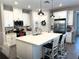 Spacious kitchen with white cabinets, stainless appliances, island and pendant lighting at 2188 Palm Tree Dr, Kissimmee, FL 34759