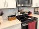 Close up view of modern kitchen appliances, white cabinets, and stylish backsplash at 2188 Palm Tree Dr, Kissimmee, FL 34759