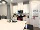 Modern kitchen featuring white cabinets, stainless steel appliances, and a stylish backsplash for a sleek design at 2188 Palm Tree Dr, Kissimmee, FL 34759