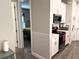 A view from the kitchen into the bedroom with hardwood floors and stainless steel appliances at 2188 Palm Tree Dr, Kissimmee, FL 34759