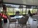 Screened lanai with outdoor furniture, a barbecue and an open view of the green lawn at 2188 Palm Tree Dr, Kissimmee, FL 34759