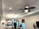 Open concept living area with fan, sight lines to kitchen and dining area at 2188 Palm Tree Dr, Kissimmee, FL 34759