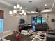 Open-concept living room with decorative lighting and sliding doors to the backyard at 2188 Palm Tree Dr, Kissimmee, FL 34759