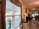 Bright living room with large windows offering scenic views of the backyard and a tranquil living space at 2188 Palm Tree Dr, Kissimmee, FL 34759
