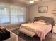 Cozy main bedroom featuring a ceiling fan, natural light from a window, a bed, and soft decor at 2188 Palm Tree Dr, Kissimmee, FL 34759