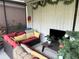 Cozy screened patio with red sectional sofa, throw pillows, and a flat screen TV at 2188 Palm Tree Dr, Kissimmee, FL 34759