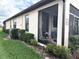 A view of the screened-in porch shows an outdoor sitting area and manicured landscaping at 2188 Palm Tree Dr, Kissimmee, FL 34759