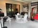 Covered porch with outdoor dining table, chairs, and a comfortable swing at 2188 Palm Tree Dr, Kissimmee, FL 34759