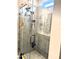 Close-up of the glass enclosed shower with grey stone look tiles and a built-in niche for toiletries at 2188 Palm Tree Dr, Kissimmee, FL 34759