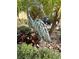 Metal heron art sculpture nestled amidst the greenery of the beautifully landscaped yard at 2188 Palm Tree Dr, Kissimmee, FL 34759