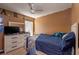 Bedroom with a cozy bed, dresser with a mirror, and a ceiling fan at 4067 Sw 46Th Ter, Ocala, FL 34474