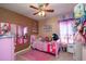 ' bedroom with a pink theme and a bed full of stuffed animals at 4067 Sw 46Th Ter, Ocala, FL 34474