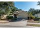 Charming home with a two-car garage, beautiful landscaping, and well-maintained front yard at 4067 Sw 46Th Ter, Ocala, FL 34474