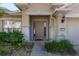 Close-up of the front door, showcasing the entrance and the home's address, complemented by the lush landscaping at 4067 Sw 46Th Ter, Ocala, FL 34474