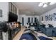 Stylishly decorated living room with modern furniture, a large TV, and a unique blue and silver color scheme at 4067 Sw 46Th Ter, Ocala, FL 34474