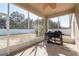View of a screened patio with a grill and a fan, perfect for outdoor cooking and relaxation at 4067 Sw 46Th Ter, Ocala, FL 34474