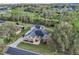 Drone shot of home surrounded by mature landscaping and large grassy yard at 6327 Ashley Dr, Lakeland, FL 33813