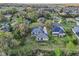 Aerial view of house on lush lot with mature trees, landscaping, and long driveway at 6327 Ashley Dr, Lakeland, FL 33813