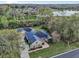 Overhead view of home with mature trees, landscaping, long driveway, and nearby lake at 6327 Ashley Dr, Lakeland, FL 33813
