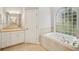 Bathroom with a large tub, separate shower and a sink and mirror at 6327 Ashley Dr, Lakeland, FL 33813