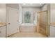 Bathroom with a large tub, a separate shower and a door at 6327 Ashley Dr, Lakeland, FL 33813
