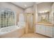 Bathroom with a large tub, separate shower and a sink and mirror at 6327 Ashley Dr, Lakeland, FL 33813