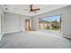 Spacious bedroom with neutral walls and carpet with large glass sliding doors leading to outside deck at 6327 Ashley Dr, Lakeland, FL 33813