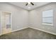 Cozy bedroom with a ceiling fan, window, and doorway at 6327 Ashley Dr, Lakeland, FL 33813