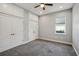 Neutral bedroom with grey carpet, a window, and built-in storage cabinets at 6327 Ashley Dr, Lakeland, FL 33813
