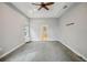 Spacious bedroom with neutral walls and carpet, a ceiling fan and an ensuite bathroom at 6327 Ashley Dr, Lakeland, FL 33813