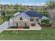 Aerial view of home's facade, with stone accents, arched windows, and lush landscaping at 6327 Ashley Dr, Lakeland, FL 33813