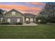 Charming one-story home boasts stone accents, arched windows, and lush landscaping at 6327 Ashley Dr, Lakeland, FL 33813