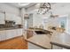 Kitchen featuring stainless steel appliances, bar seating, and hardwood floors with lots of natural light at 6327 Ashley Dr, Lakeland, FL 33813