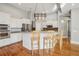 Kitchen island with barstool seating, stainless steel appliances, and hardwood floors at 6327 Ashley Dr, Lakeland, FL 33813