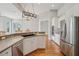 Open kitchen featuring stainless steel appliances, granite countertops, and hardwood floors at 6327 Ashley Dr, Lakeland, FL 33813